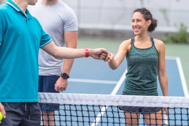 istock Three tennis players congratulate each other after a match 1078703522