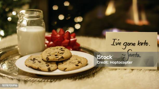 Ketogenic Christmas Santa Politely Refuses Milk And Cookies With A Ive Gone Keto Note By The Fireplace On Christmas Eve Stock Photo - Download Image Now