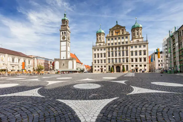 Stock photograph of the Town Hall and the Perlachturm on Elias Holl Platz in downtown Augsburg, Bavaria, Germany on a sunny day.