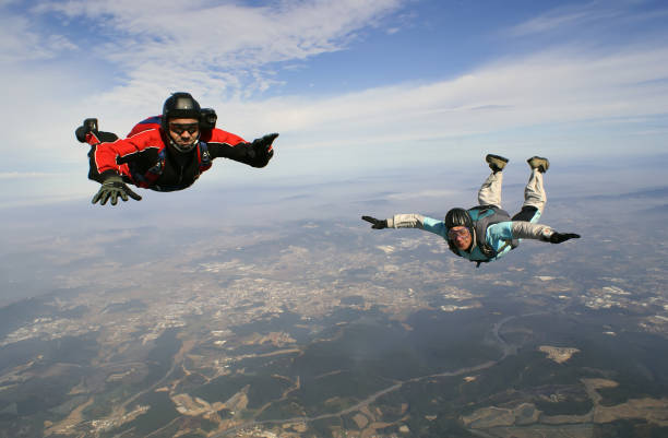 istock A young and old man jumping from parachute together. 1078707978
