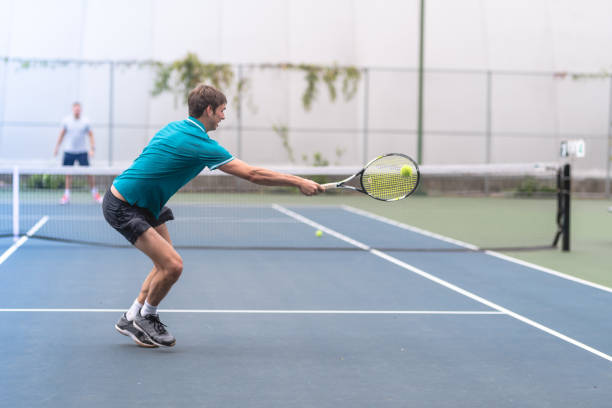 istock Two males playing outdoor tennis 1078710106