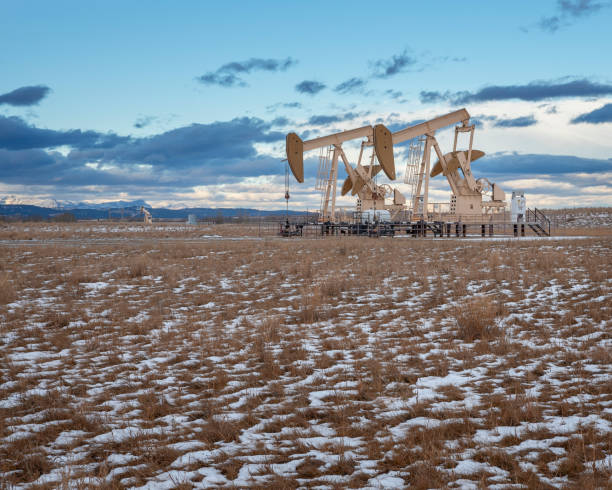 Oil Wells in Alberta winter landscape of oil wells in Alberta oil pump oil industry alberta equipment stock pictures, royalty-free photos & images