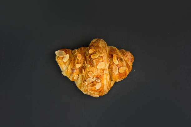 istock Fresh baked croissant on black background. 1078722532