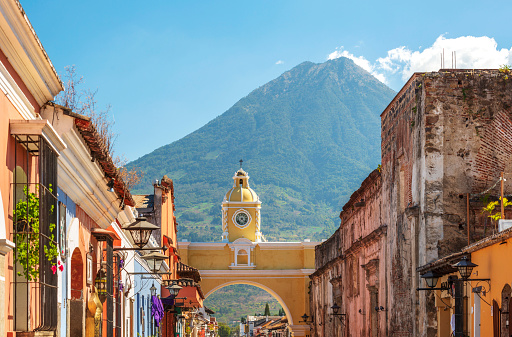 Antigua Guatemala, classic colonial town with famous Arco de Santa Catalina and Volcan de Agua behind