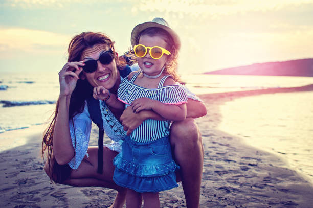 istock Mother and daughter by the sea 1078730190