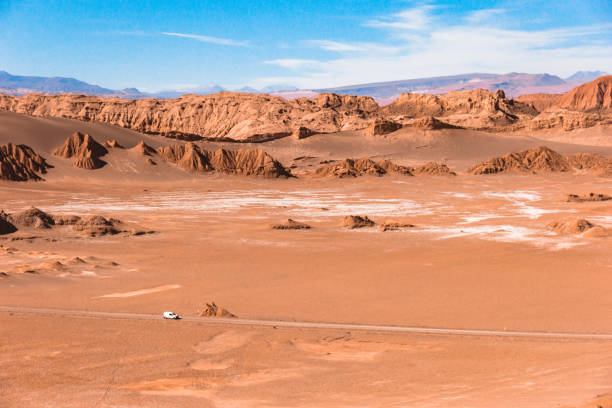 Vehicle in the distance crossing the Atacama desert. Taken by Canon 60D during a trip at Atacama desert with my love. atacama desert photos stock pictures, royalty-free photos & images