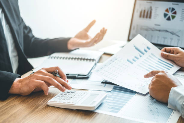 Co-working Business Team meeting Planning Strategy Analysis investment and saving concept. meeting discussing new plan financial graph data. stock photo