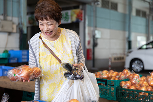 Japanese senior woman shopping at fish market