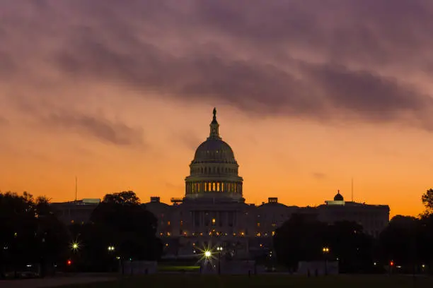Photo of Cloudy sunrise above US Capitol.