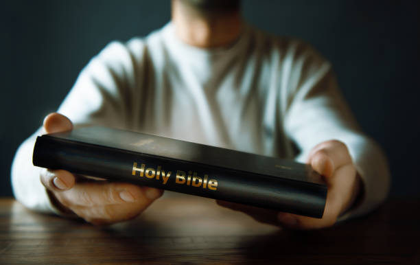 istock man hand Holy Bible 1078835776
