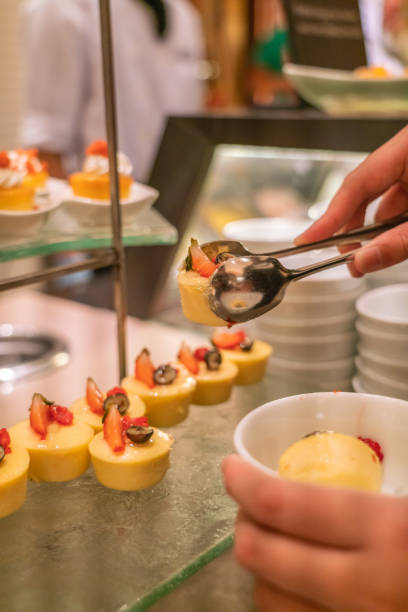 istock Man hand taking Cheese Cake in the buffet 1078845018