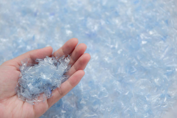 Woman hand holding Bottle flake,PET bottle flake,Plastic bottle crushed,Small pieces of cut blue plastic bottles Woman hand holding Bottle flake,PET bottle flake,Plastic bottle crushed,Small pieces of cut blue plastic bottles polypropylene stock pictures, royalty-free photos & images