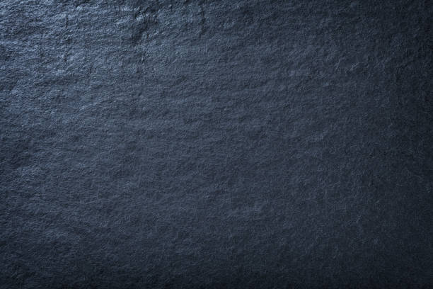 Photo of Dark blue background of natural slate. Texture of stone