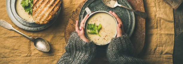 istock Celery cream soup, grilled bread and female hands, wide composition 1078903124