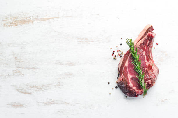 istock Raw veal steak on the bone. Free space for your text. Top view. 1078903396