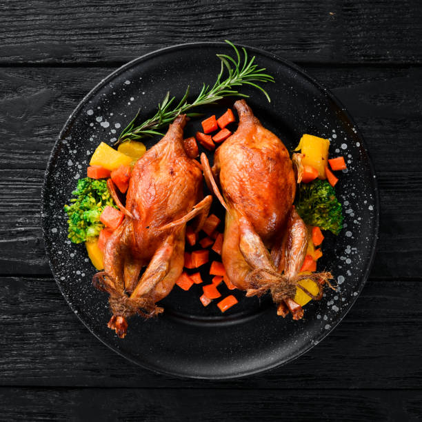 istock Baked quail. On a black background. Top view. Free space for your text. 1078903582
