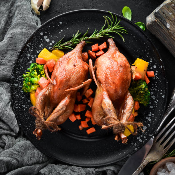 istock Baked quail. On a black background. Top view. Free space for your text. 1078903596