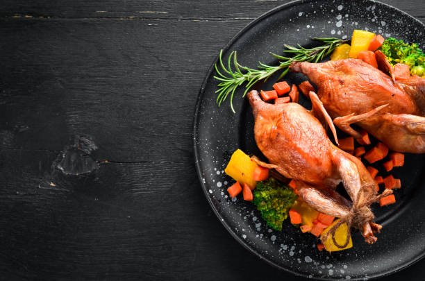 istock Baked quail. On a black background. Top view. Free space for your text. 1078910450
