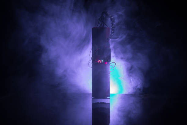 istock Image of a time bomb against dark background. Timer counting down to detonation illuminated in a shaft light shining through the darkness, 1078911160