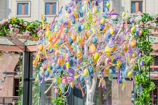 colorfull easter egg tree. brights eggs hanging from branches.