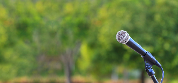 microphone standing for speaker on the outdoor natural setting for music, concert and environmental awareness talk
