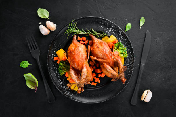 istock Baked quail. On a black background. Top view. Free space for your text. 1078929122