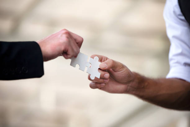 istock Cropped Hands Holding Jigsaw Puzzle 1078932546