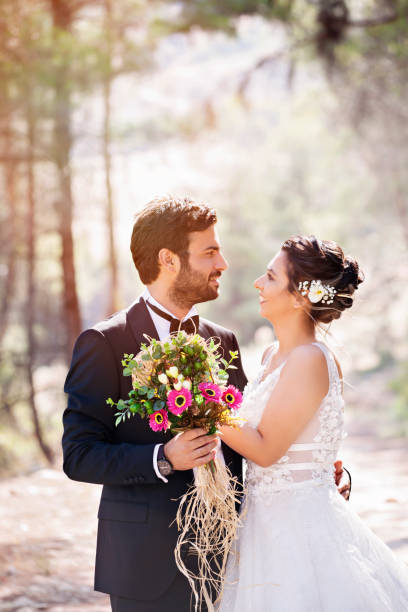 istock Happy wedding couple posing in nature 1078937664