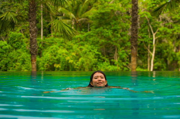 istock Young Attractive Asian Woman Swimming 1078941296