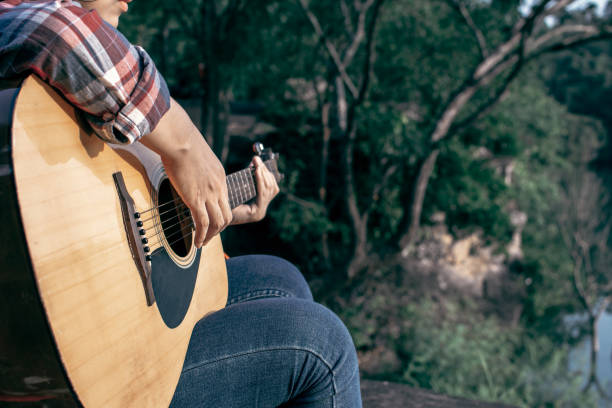 istock Midsection Of Woman Playing Guitar 1078948162