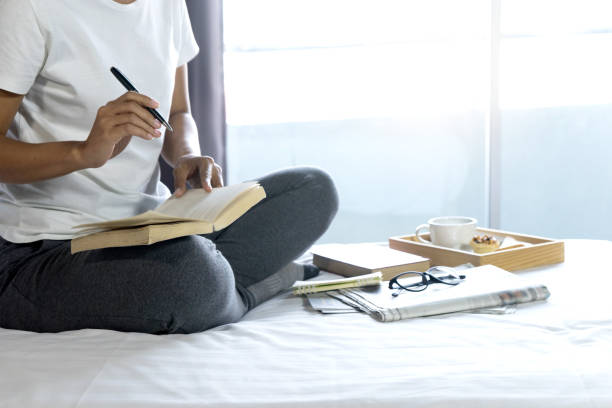 istock relax woman read a book on the bed 1078951730