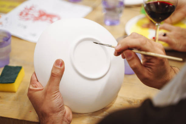 istock Man's hands painting a ceramic plate in an art Studio. 1078954114