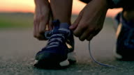 istock SLO MO Woman tying shoelaces on running shoes 1078964184