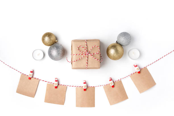 istock Golden and silver balls, gift, candles, notes with wish on clothespins, Top view White Background Christmas New Year 1078977666