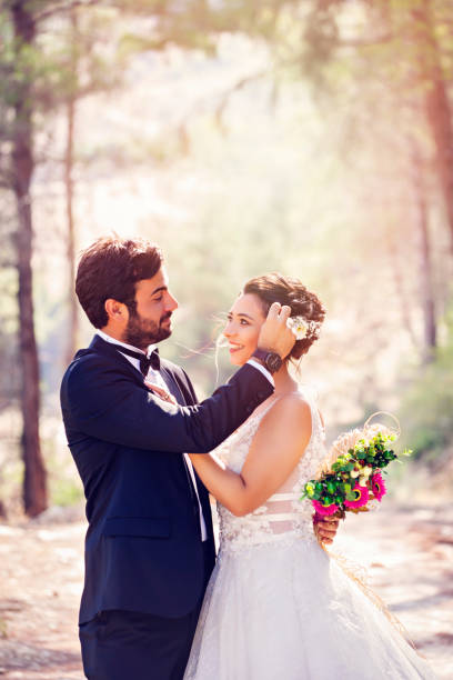 istock Happy wedding couple posing in nature 1078979098