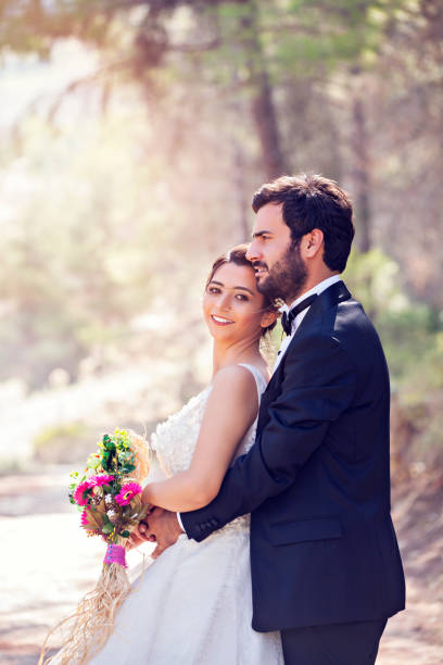 istock Happy wedding couple posing in nature 1078982400