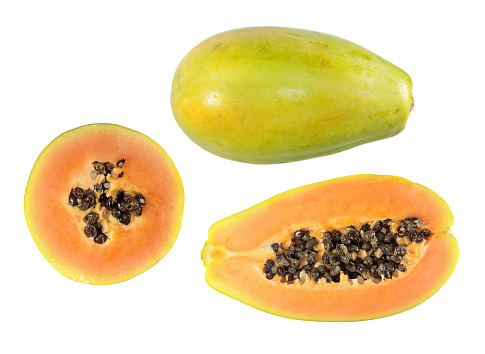 Set of half cut and whole papaya fruits isolated on white background