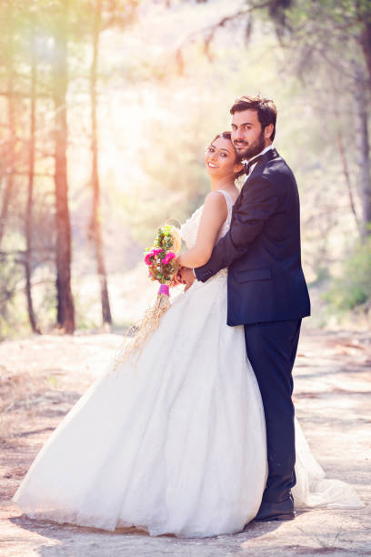 istock Happy wedding couple posing in nature 1078990706