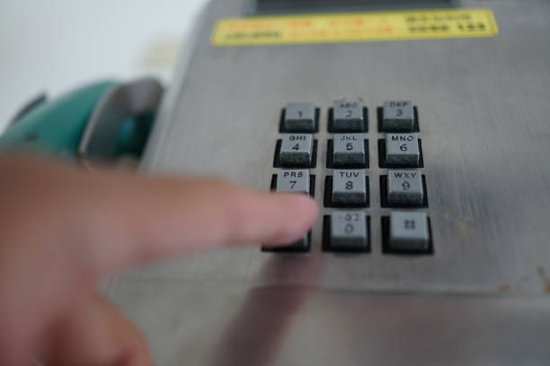 istock Man's hand with public phone. 1078996984
