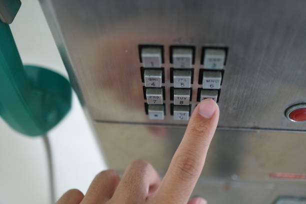 istock Man's hand with public phone. 1078997210