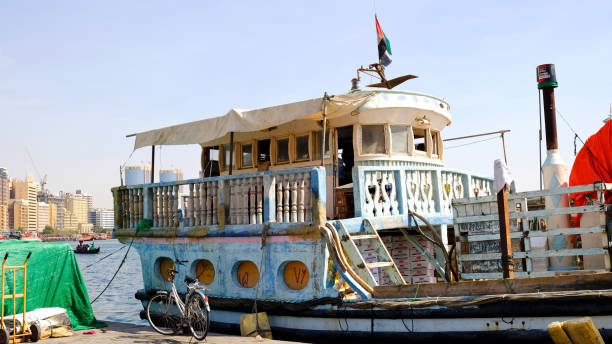 Deira, United Arab Emirates  - November 1, 2018: Traditional wooden Dhow or trading boat waiting in the old port of downtown Deira