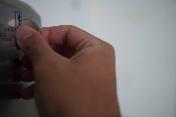 istock Man's hand with public phone. 1078998724