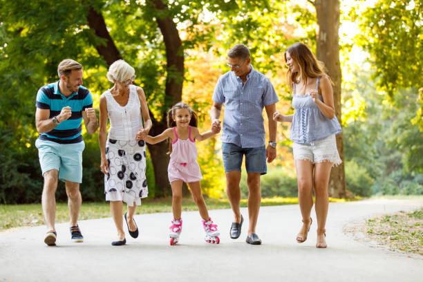 istock Grandparents assisting their granddaughter while roller skating 1079002784