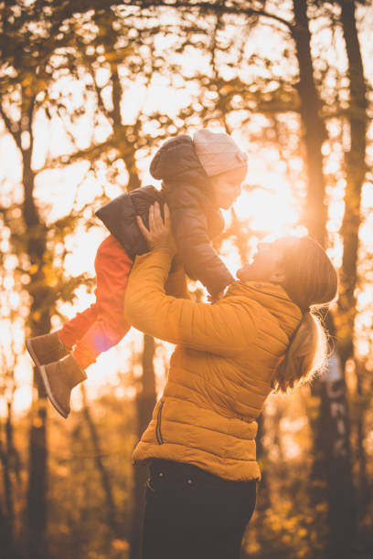 istock Mother and daughter having fun on a sunny autumn day 1079003002