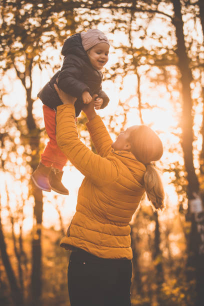 istock Mother and daughter having fun on a sunny autumn day 1079003024