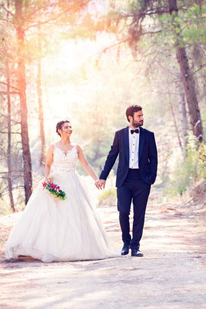 istock Wedding couple walking on forest road. 1079003860