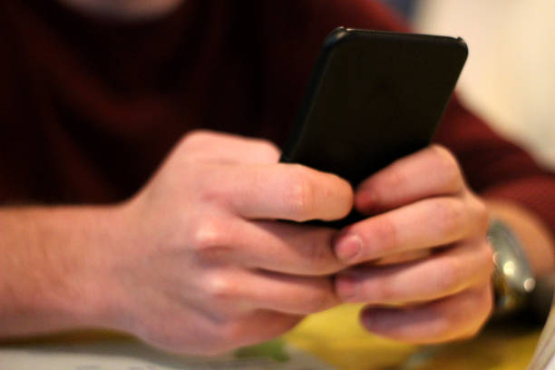 istock Young man with smartphone in hand 1079005588