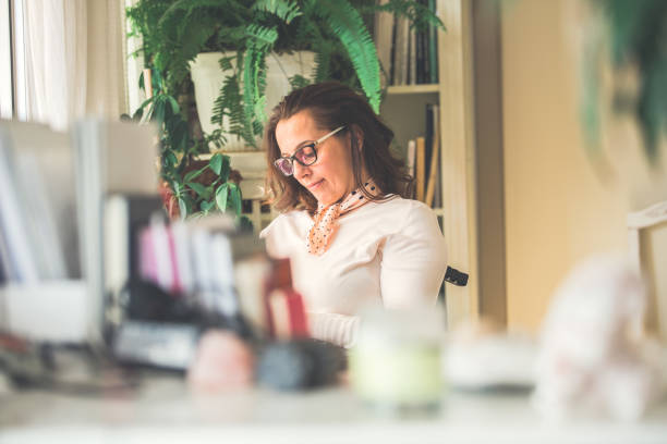 istock Woman reading book in home study 1079011148