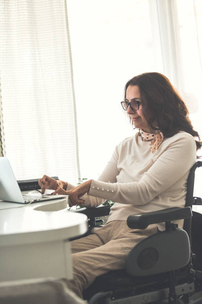 istock Businesswoman in wheelchair checking e-mails 1079013006