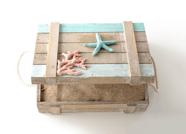 Opened wooden chest full with sand, on white background.